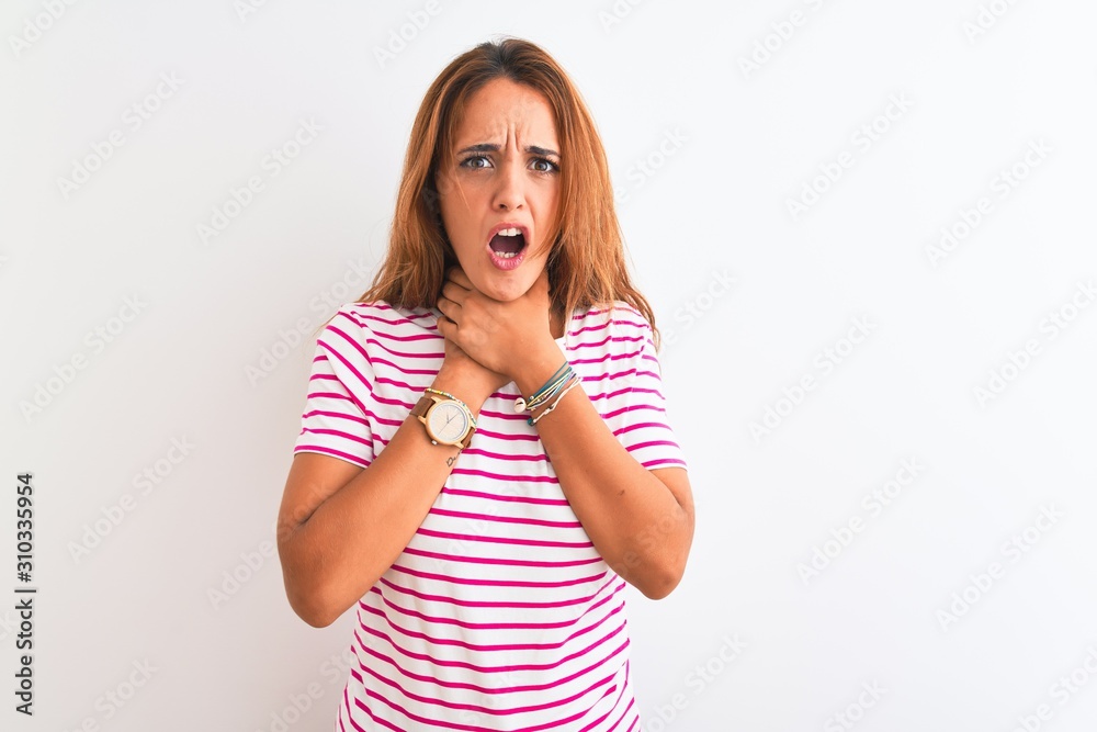 Young redhead woman wearing striped casual t-shirt stading over white isolated background shouting and suffocate because painful strangle. Health problem. Asphyxiate and suicide concept. Young redhead woman wearing striped casual t-shirt stading over white isolated background shouting and suffocate because painful strangle. Health problem. Asphyxiate and suicide concept.