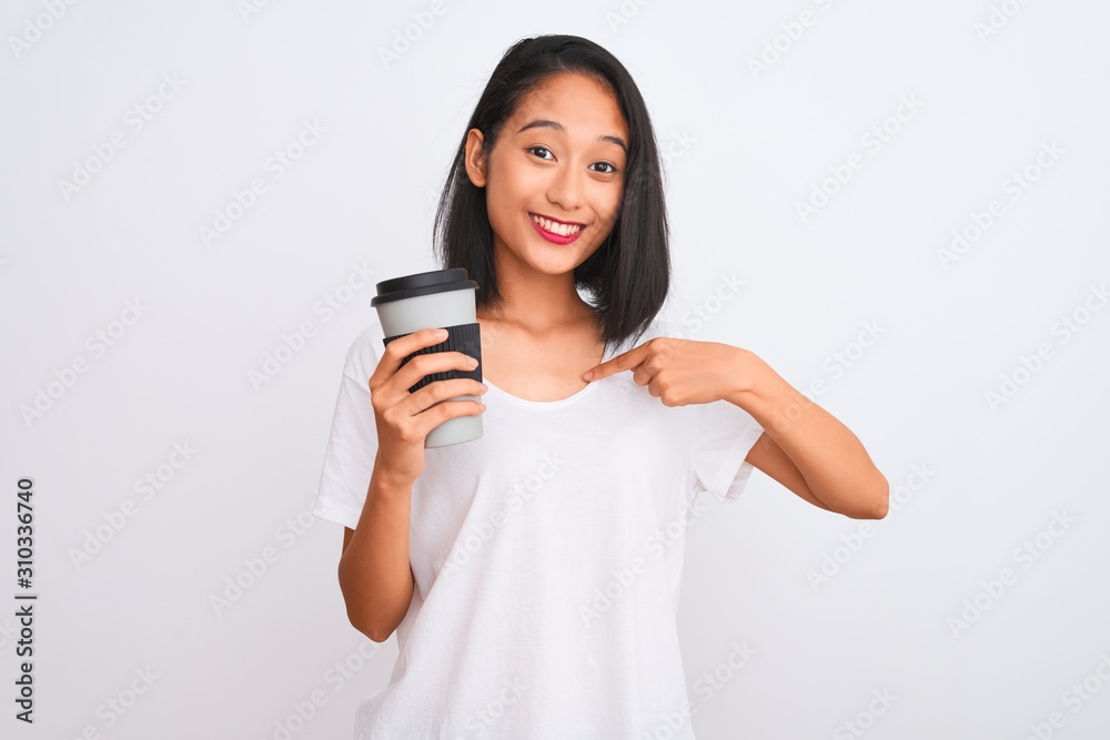 Young chinese woman drinking take away glass of coffee over isolated white background with surprise face pointing finger to himself Young chinese woman drinking take away glass of coffee over isolated white background with surprise face pointing finger to himself