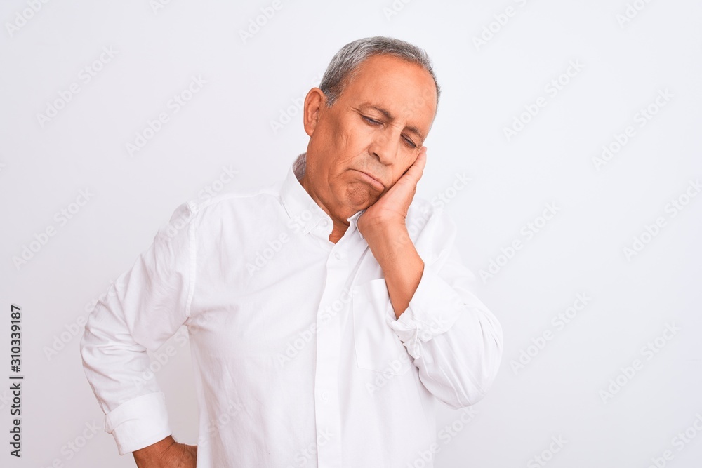 Senior grey-haired man wearing elegant shirt standing over isolated white background thinking looking tired and bored with depression problems with crossed arms. Senior grey-haired man wearing elegant shirt standing over isolated white background thinking looking tired and bored with depression problems with crossed arms.