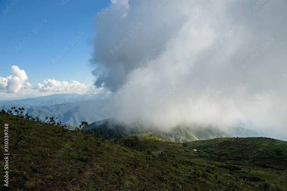 Panoramic view of beautiful mountain landscape in Doi Pui Luang with green mountain pastures with cloud and sun lights. Mae Ngao National park in north of Thailand.