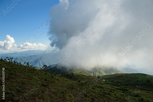 Panoramic view of beautiful mountain landscape in Doi Pui Luang with green mountain pastures with cloud and sun lights. Mae Ngao National park in north of Thailand.