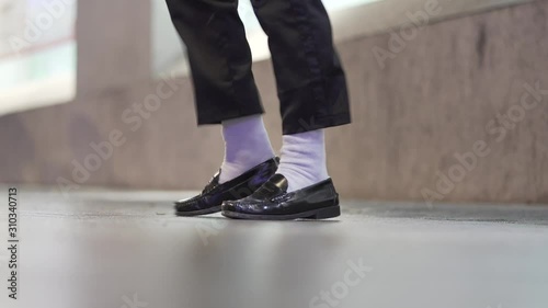 Close-up feet dancing with white socks and black shoe photo