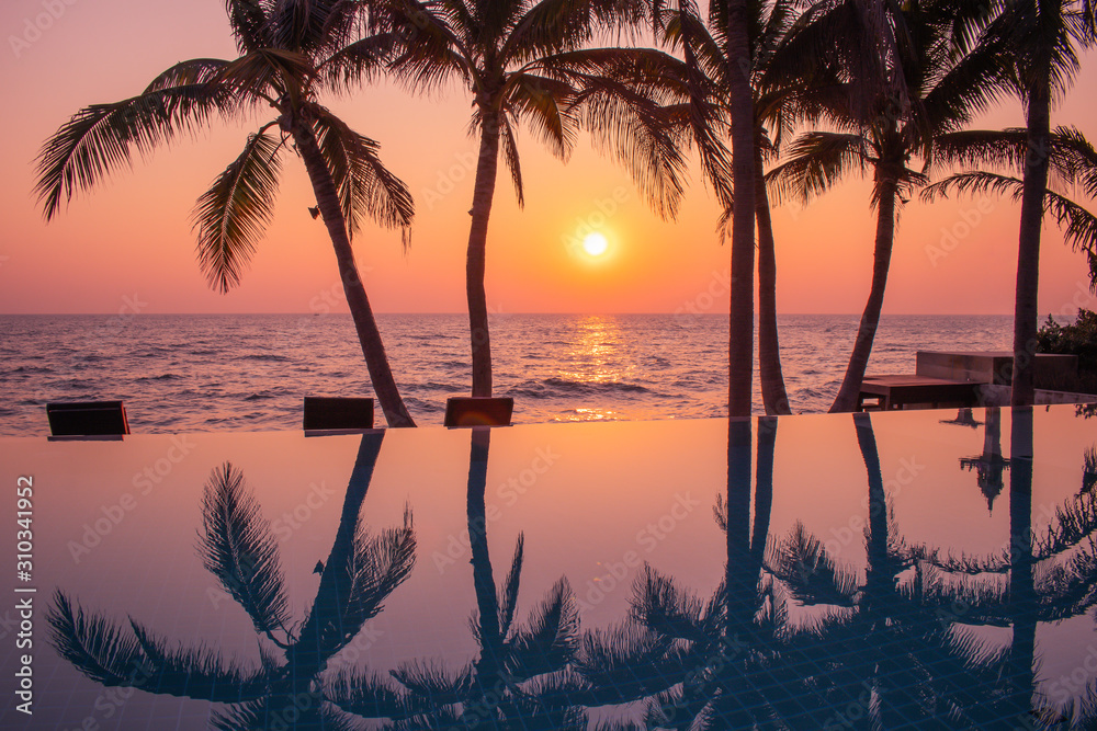 Beautiful seascape view in golden time, Silhouette of coconut trees with sunrise in background.