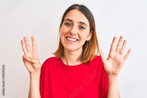 Beautiful redhead woman wearing casual red t-shirt over isolated background showing and pointing up with fingers number eight while smiling confident and happy.