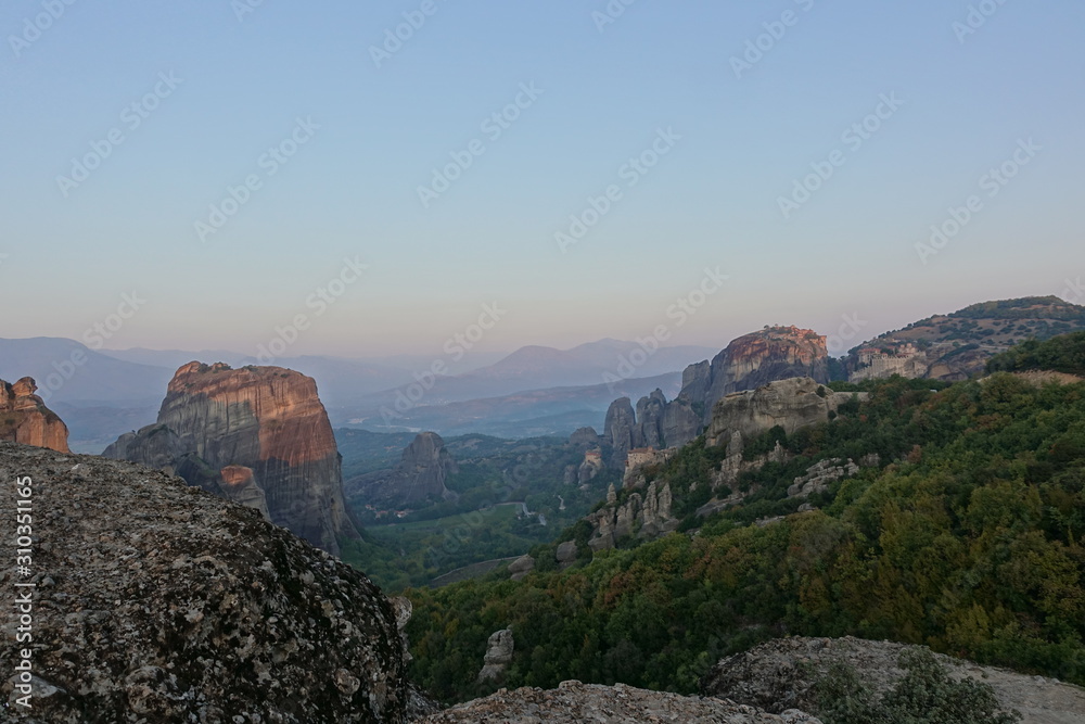 The Holy Monastery of Roussanou and Monastery of Agios Nikolaos Anapafsas situated on the steep cliffs, mountains panorama, Kalampaka, Trikala, Thessaly, Greece