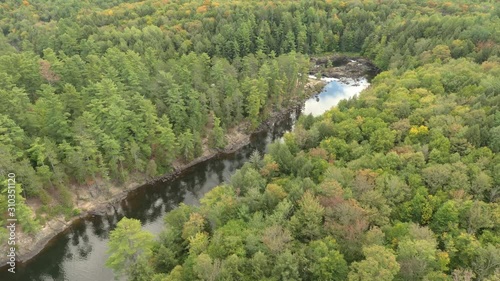 Stunning aerial shot of river flowing thru pines and turning sharp elbow shape photo