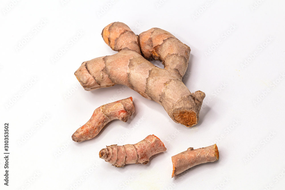 Close up Turmeric root with slices isolate on white background with clipping path.(Curcuma longa Linn) Close up Turmeric root with slices isolate on white background with clipping path.(Curcuma longa Linn)