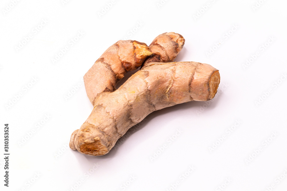 Close up Turmeric root with slices isolate on white background with clipping path.(Curcuma longa Linn)