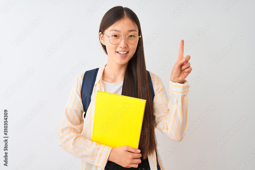 Chinese student woman wearing glasses backpack book over isolated white background surprised with an idea or question pointing finger with happy face, number one Chinese student woman wearing glasses backpack book over isolated white background surprised with an idea or question pointing finger with happy face, number one