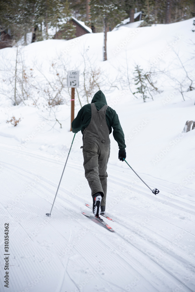 snowboarder enjoying skiing in mountains in the evening on the slope at winter ski resort