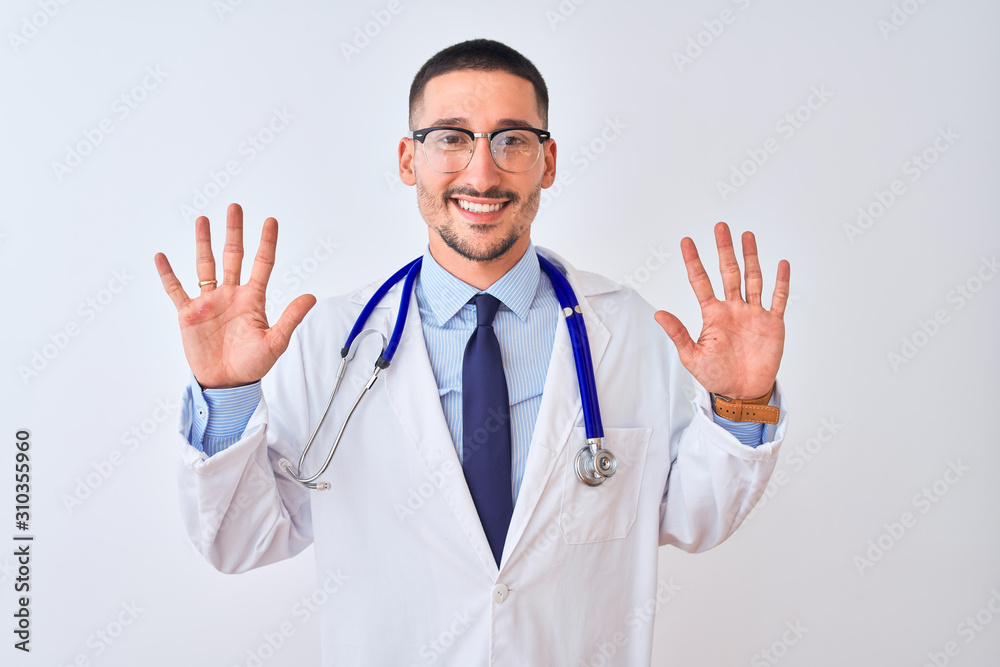 Young doctor man wearing stethoscope over isolated background showing and pointing up with fingers number ten while smiling confident and happy.