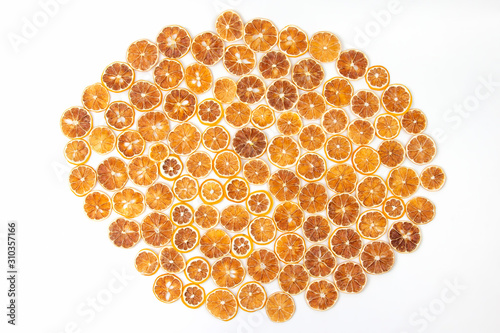 large number of dried lemon slices on a white background. vitamin fruit food