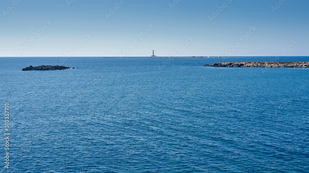 View At Isola del Campo (Island of The Field) And It's Lighthouse During a Bright Sunny Day At Gallipoli Puglia Italy