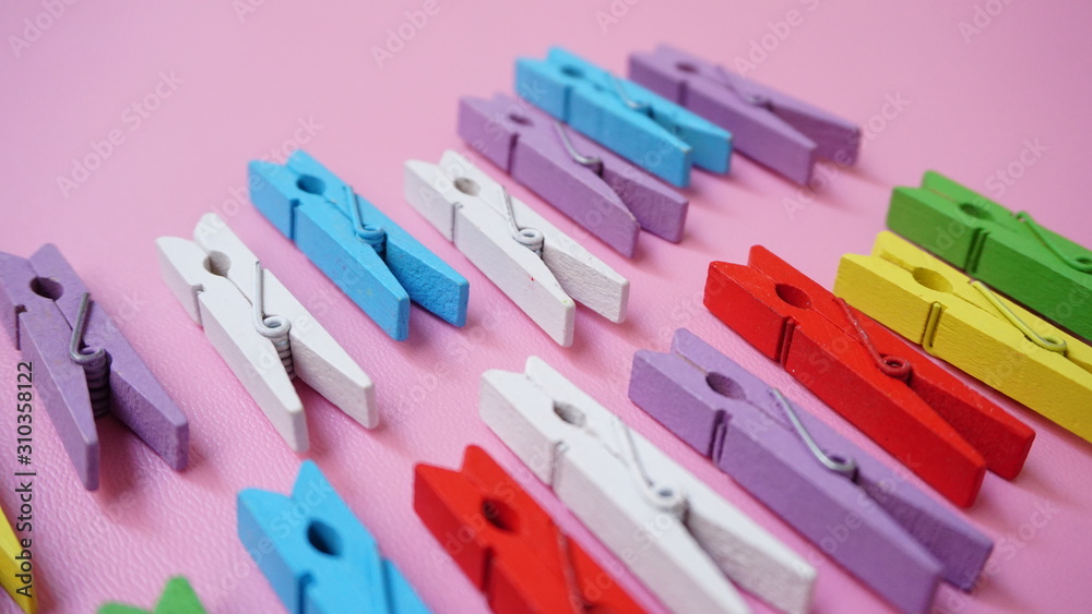 colorful clothes pegs on blue background Stock Photo | Adobe Stock