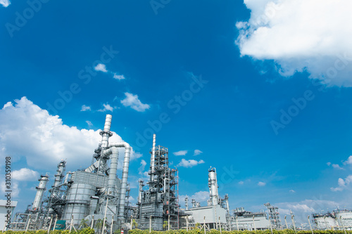 Oil and gas industrial,Oil refinery plant form industry,Refinery factory oil storage tank and pipeline steel blue sky background