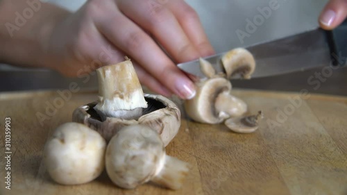 Close Up Woman Hands Cutting Mashroom on Wooden Chopping Board