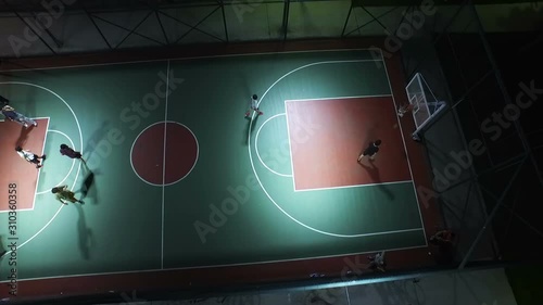 Basketball Players Playing in Court at Night, İstanbul Turkey photo