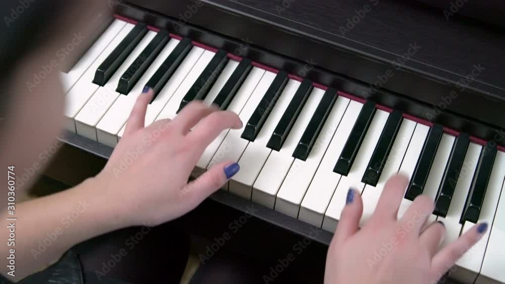Young Female Pianist Hands Playing Grand Piano Top View
