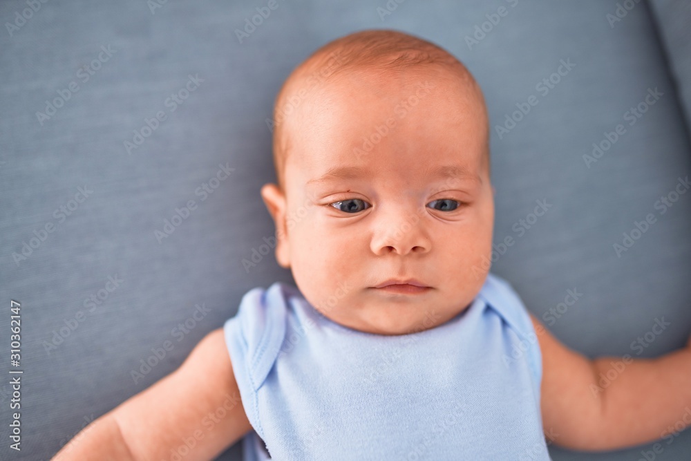 Adorable baby lying down on the sofa at home. Newborn relaxing and resting comfortable Adorable baby lying down on the sofa at home. Newborn relaxing and resting comfortable