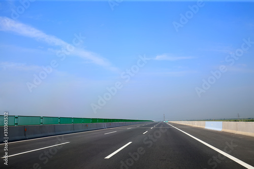 Beautiful highway, under the blue sky and white clouds