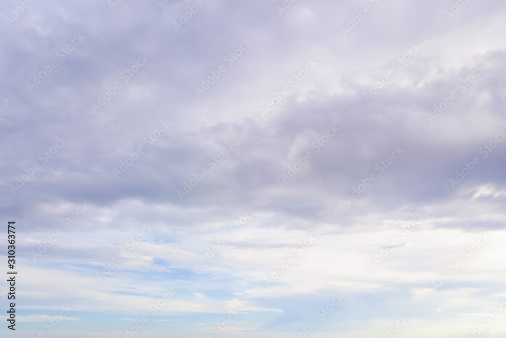 Blue sky with soft white and gray clouds. Natural background and texture.
