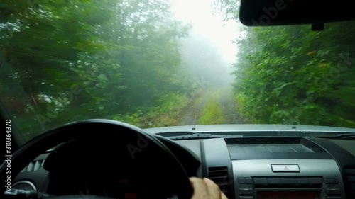 Driving dangerous foggy mountain dirt road without visiblity, Rize, Turkey photo