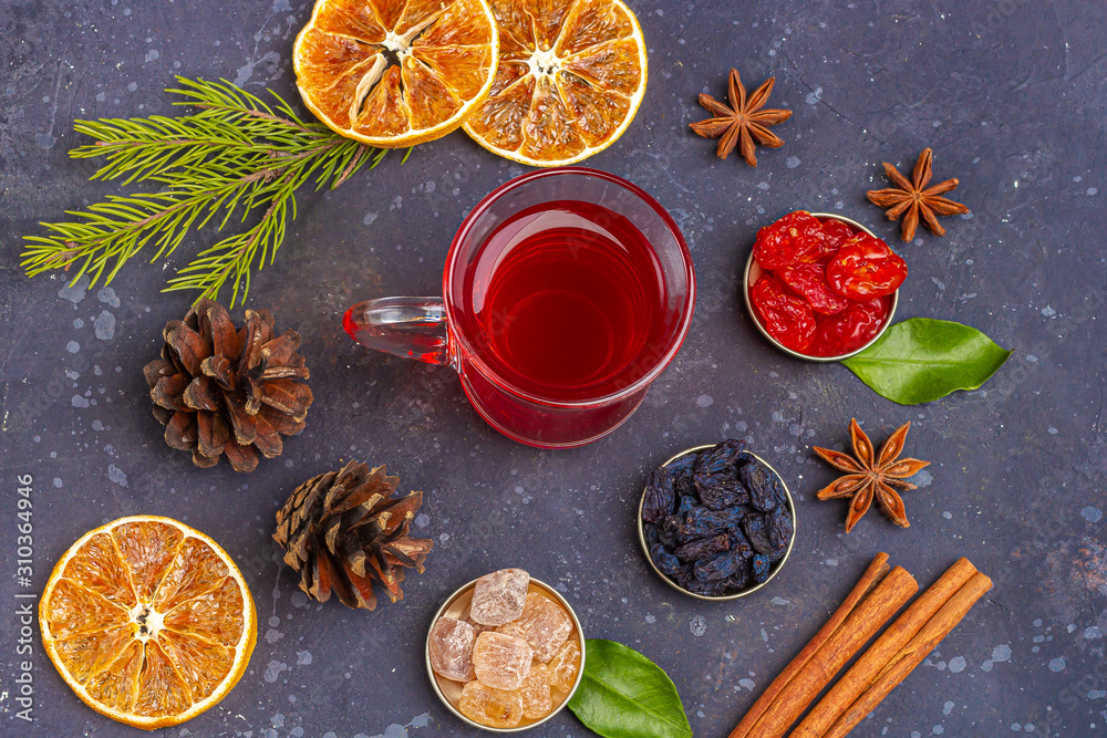 Hot spicy Christmas home made drink. Mulled wine, cranberry punch or Sangria with cranberries and orange for feast in oriental style. Winter holidays concept. Close up, copy space for text, flat lay Hot spicy Christmas home made drink. Mulled wine, cranberry punch or Sangria with cranberries and orange for feast in oriental style. Winter holidays concept. Close up, copy space for text, flat lay