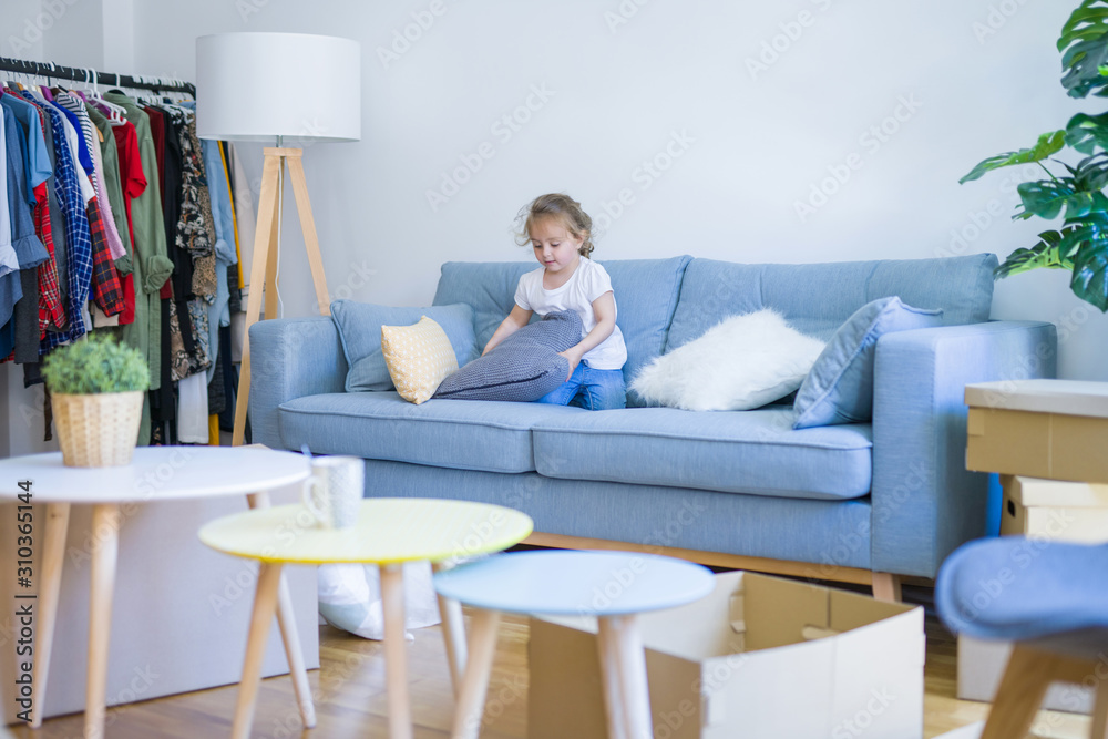 Beautiful toddler child girl jumping on the sofa Beautiful toddler child girl jumping on the sofa
