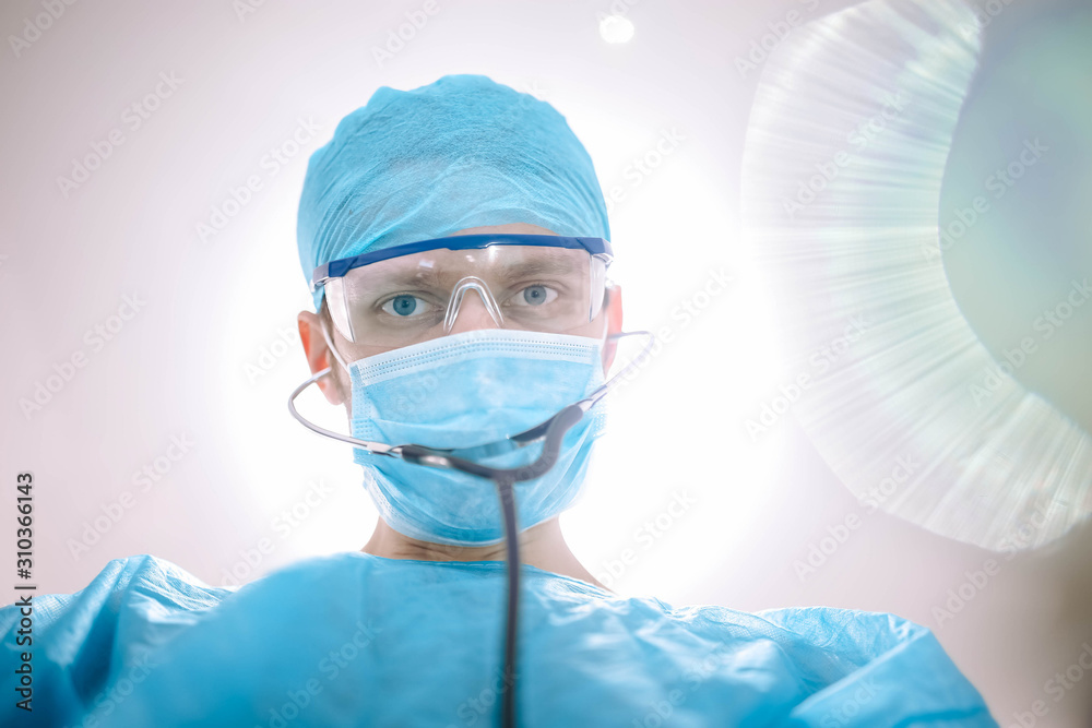 Doctor male surgeon in uniform working with a stethoscope in a medical office. Doctor male surgeon in uniform working with a stethoscope in a medical office.