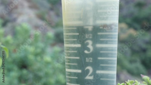 Close up of rain gauge in garden.