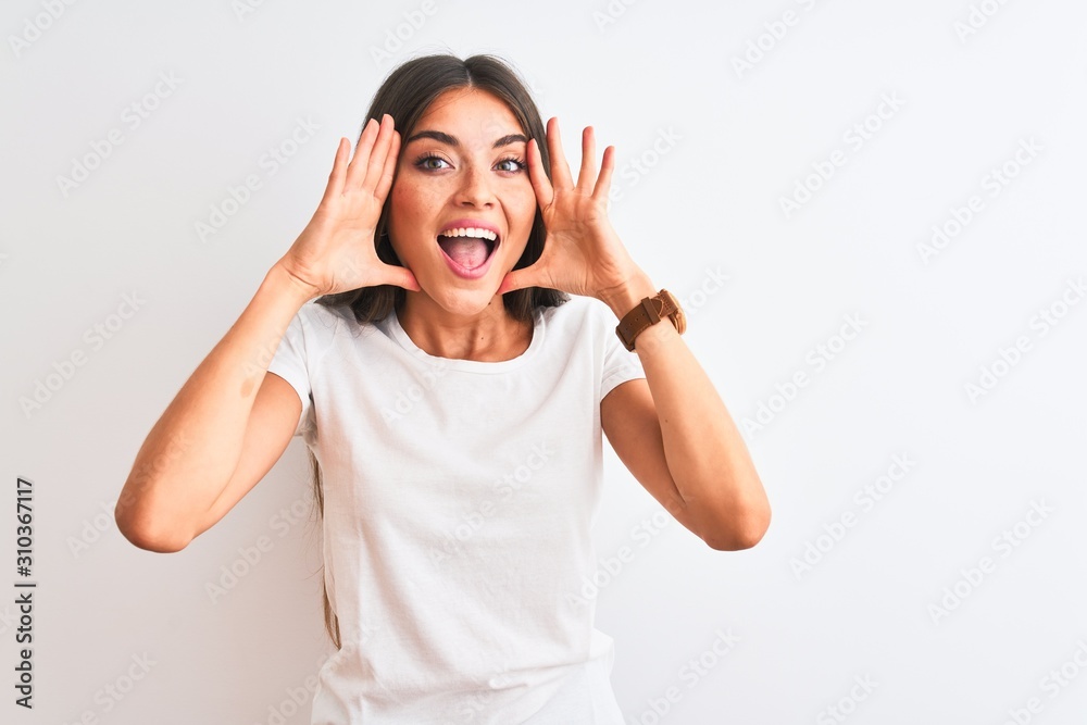 Young beautiful woman wearing casual t-shirt standing over isolated white background Smiling cheerful playing peek a boo with hands showing face. Surprised and exited Young beautiful woman wearing casual t-shirt standing over isolated white background Smiling cheerful playing peek a boo with hands showing face. Surprised and exited