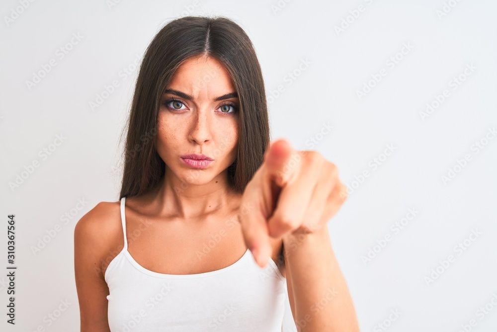 Young beautiful woman wearing casual t-shirt standing over isolated white background pointing with finger to the camera and to you, hand sign, positive and confident gesture from the front Young beautiful woman wearing casual t-shirt standing over isolated white background pointing with finger to the camera and to you, hand sign, positive and confident gesture from the front
