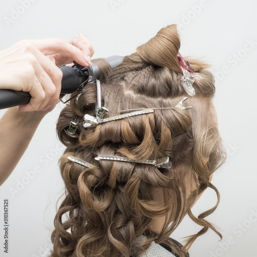 Hairdresser create the image of the bride blonde. Close up. 