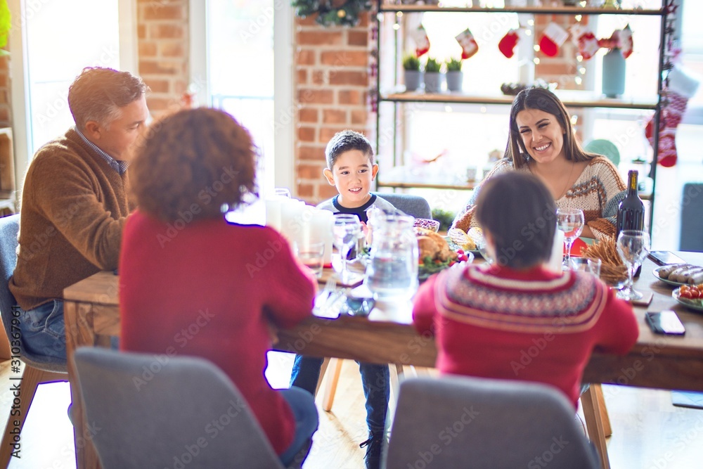 Beautiful family smiling happy and confident. Eating roasted turkey celebrating christmas at home