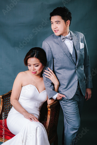 Konstfotografi Young asian groom and bride posing and smiling in studio for pre-wedding shot