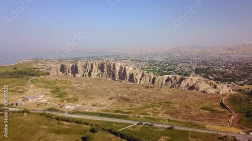 Historical Eastern fortress, Van Castle on rocky hill and mosques photo