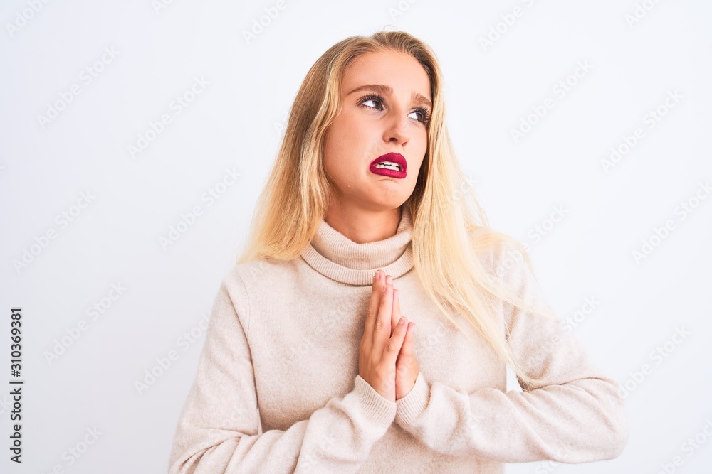 Young beautiful woman wearing turtleneck sweater standing over isolated white background begging and praying with hands together with hope expression on face very emotional and worried. Asking 