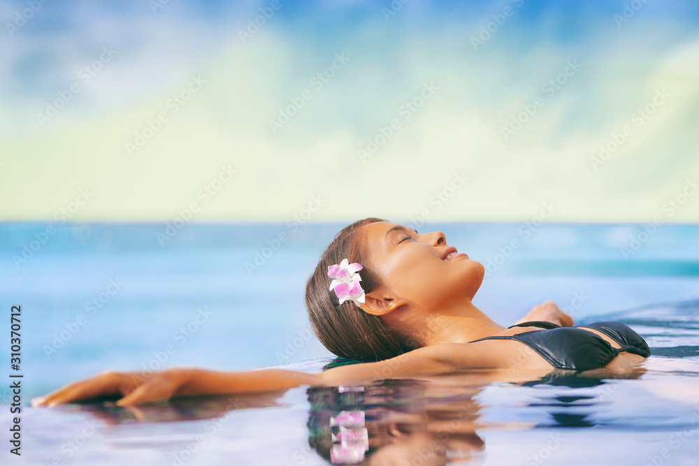 Luxury wellness spa resort Asian woman relaxing swimming in infinity ...