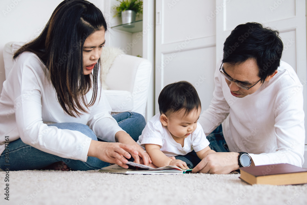 Asian father and mother tell stories from picture books to their baby.Happy family concept. Asian father and mother tell stories from picture books to their baby.Happy family concept.