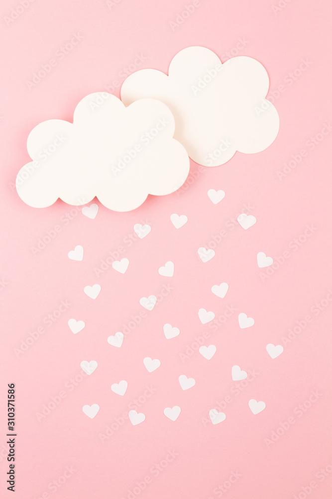 White paper hearts and clouds over pink background. Abstract background with paper cut shapes. Sainte Valentine, mother's day, birthday greeting cards, invitation, celebration