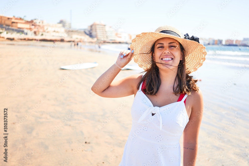 Young beautiful woman smiling happy enjoying summer vacation at the medano beach in Gran Canaria