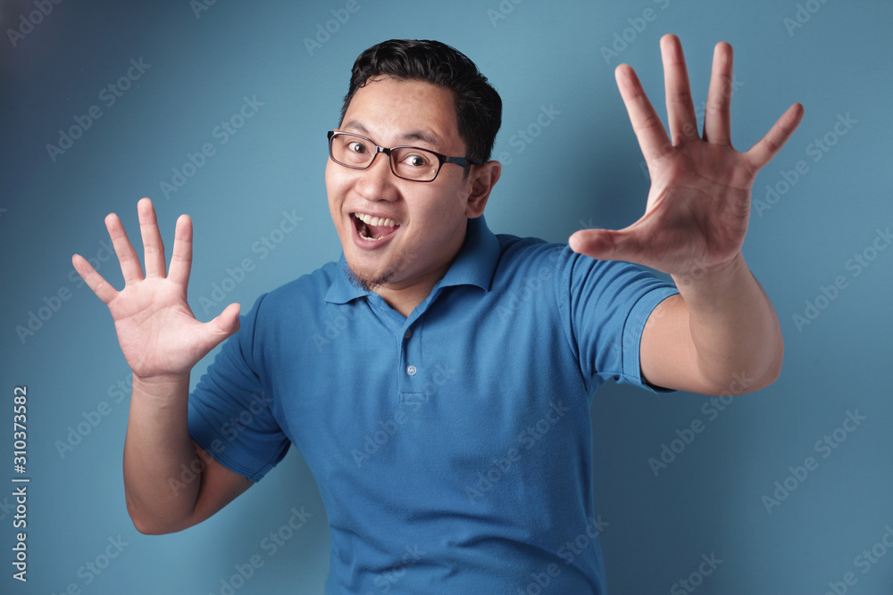 Happy man smiling and shows palm up, excited surprised gesture Happy man smiling and shows palm up, excited surprised gesture