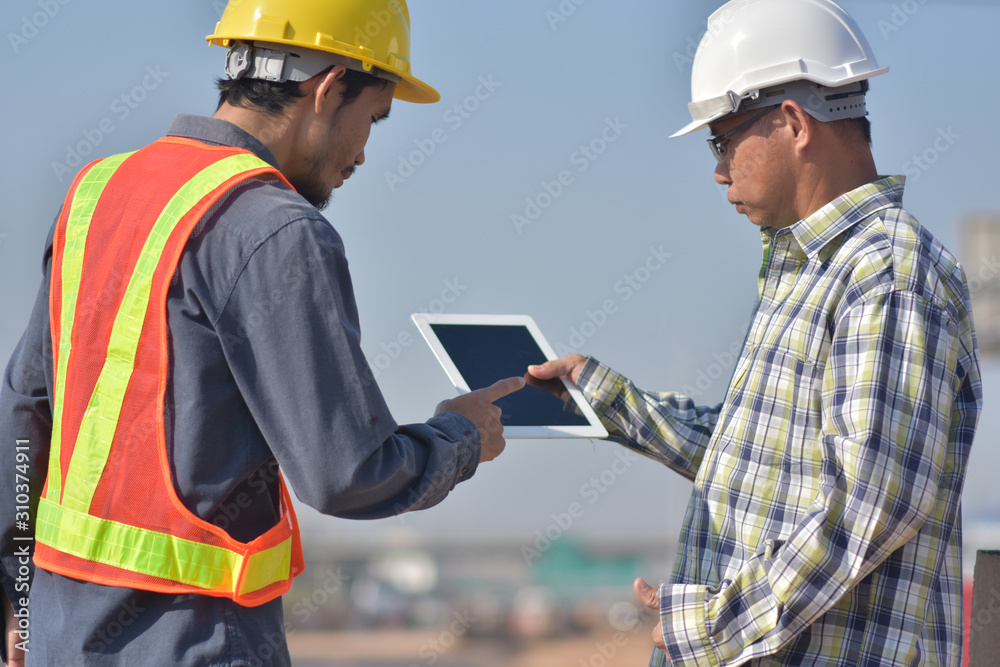 Construction Engineering holding tablet and choice tools equipment application on tablet technology to work building construction concept work easy by technology