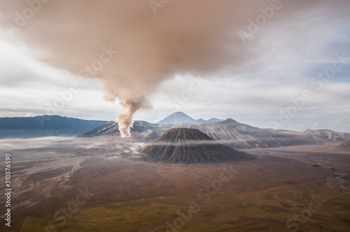 The eruption of mount Bromo darken the surrounding sky. © Putu