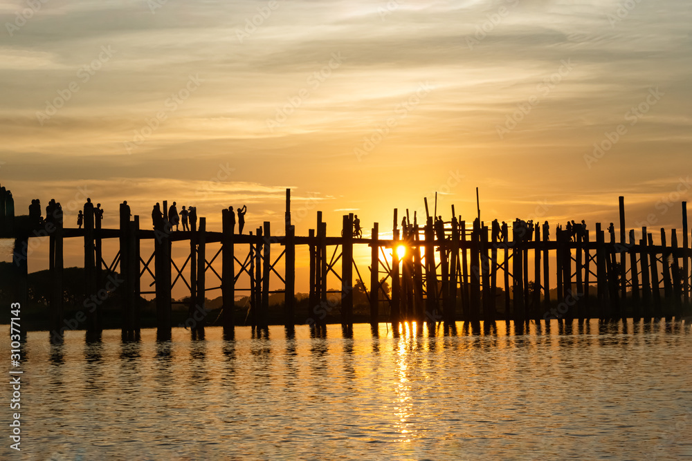 nature scene of Silhouette longest wooden bridge  in Mandalay,  This place is famous landmark in Mandalay, Myanmar