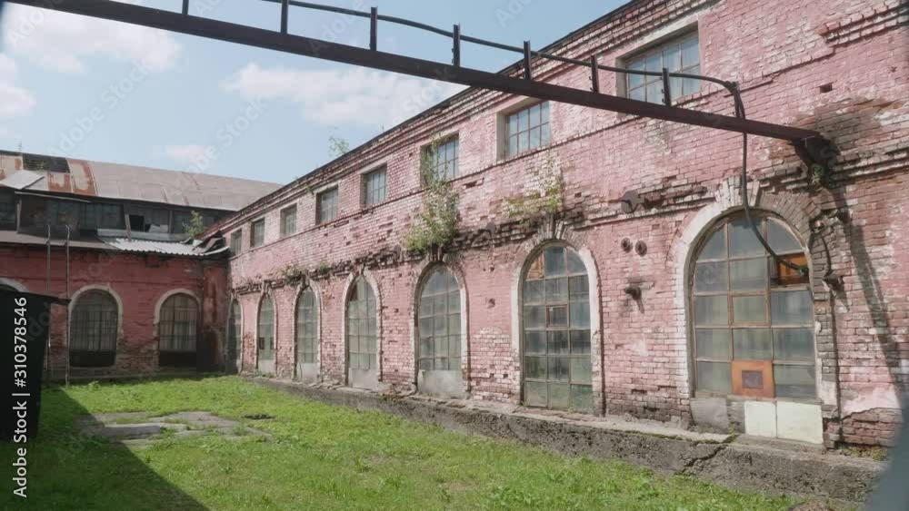 Territory of abandoned metallurgical plant with building of warehouse built with red brick. Territory of abandoned metallurgical plant with building of warehouse built with red brick.