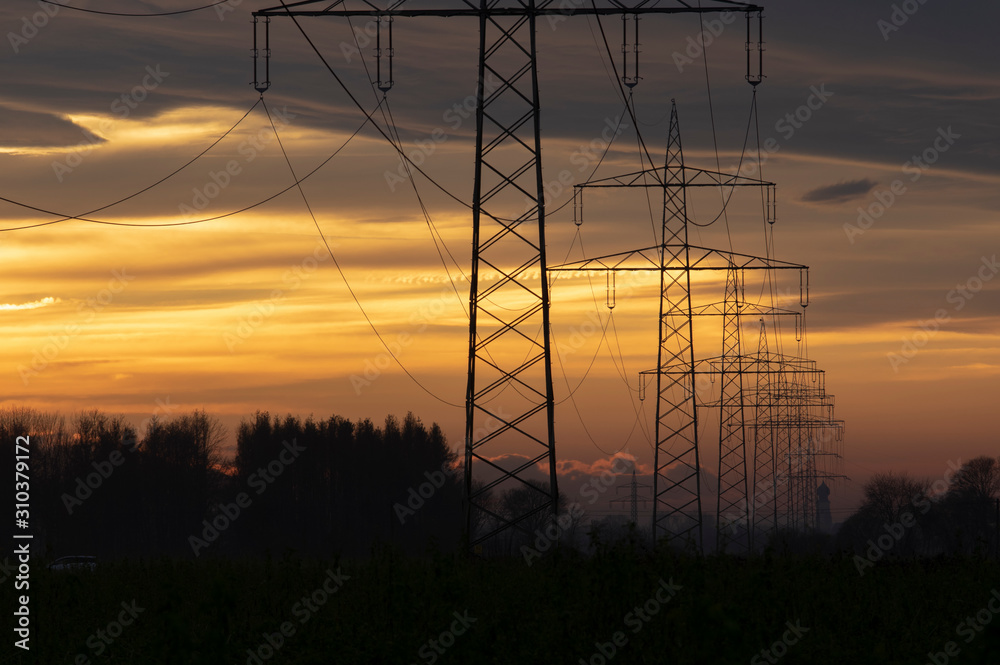electricity pylons  power line at orange sunset