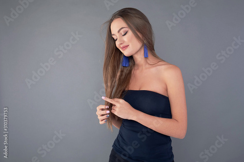 Woman with beauty long brown hair, posing at studio.