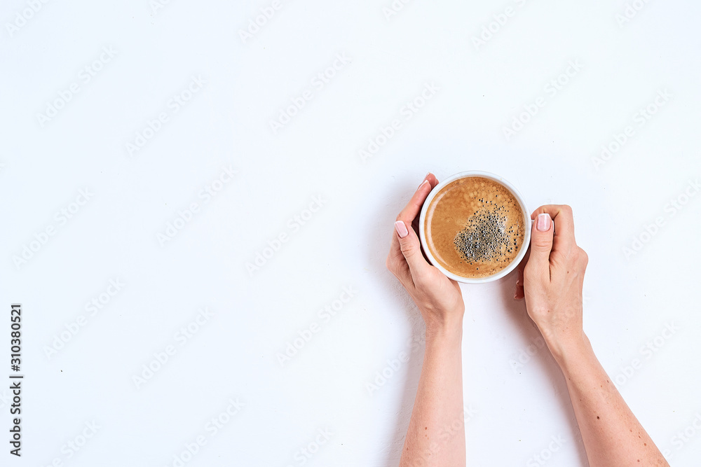 Fototapeta premium Female hand hold coffee cup on wood table. Top view