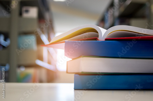 Open book on wood desk in library.